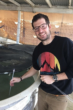 2021 Bay-Delta Science Conference oral presentation second place awardee Kenneth W. Zillig standing next to a fish tank.